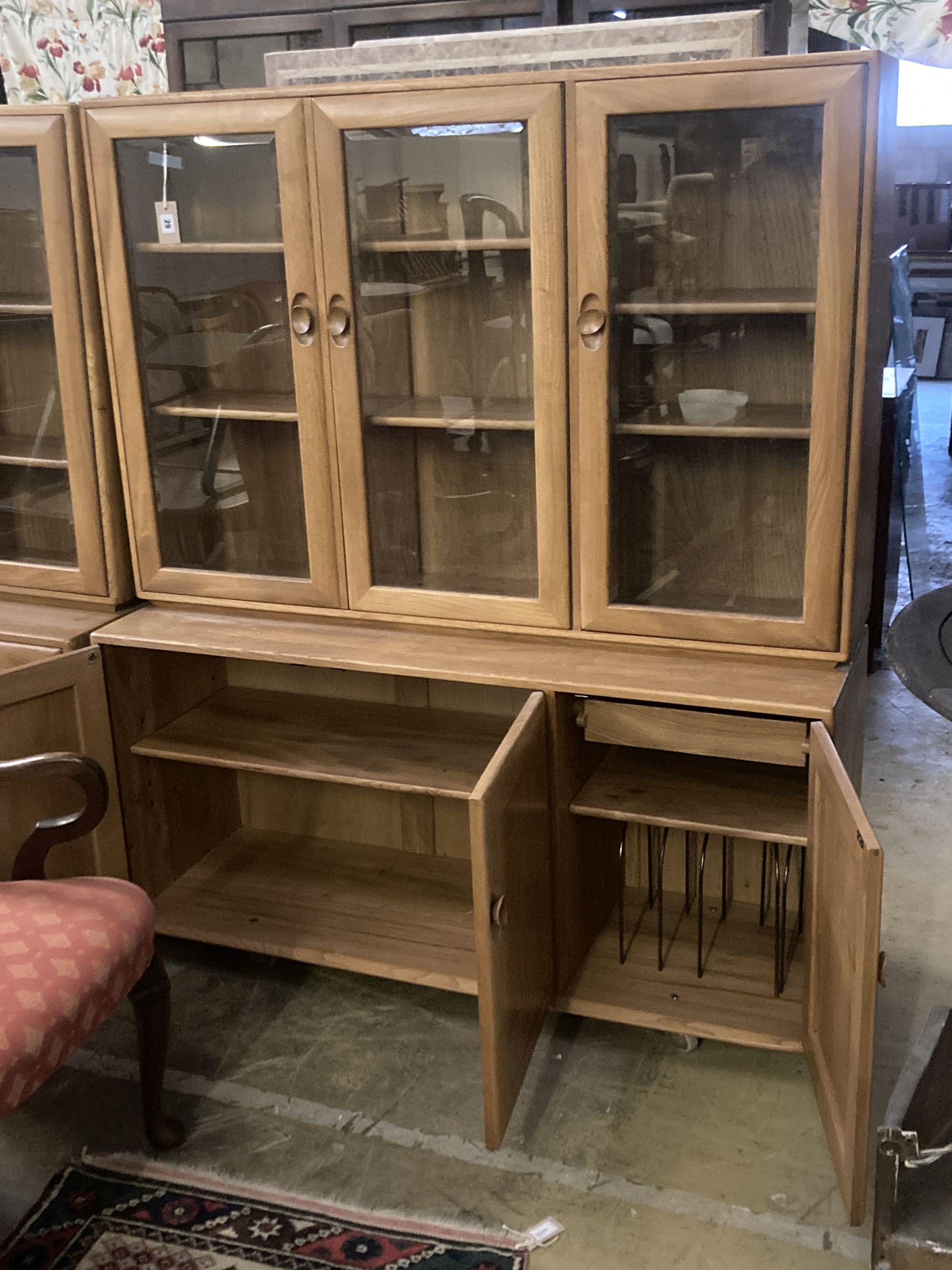 An Ercol display cabinet fitted three glazed panelled doors over cupboards, width 136cm depth 44cm height 162cm